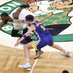 Boston Celtics guard Jaylen Brown (7) and Golden State Warriors guard Klay Thompson (11) scramble after a loose ball during the second quarter of Game 6 of basketball's NBA Finals, Thursday, June 16, 2022, in Boston. (AP Photo/Michael Dwyer)