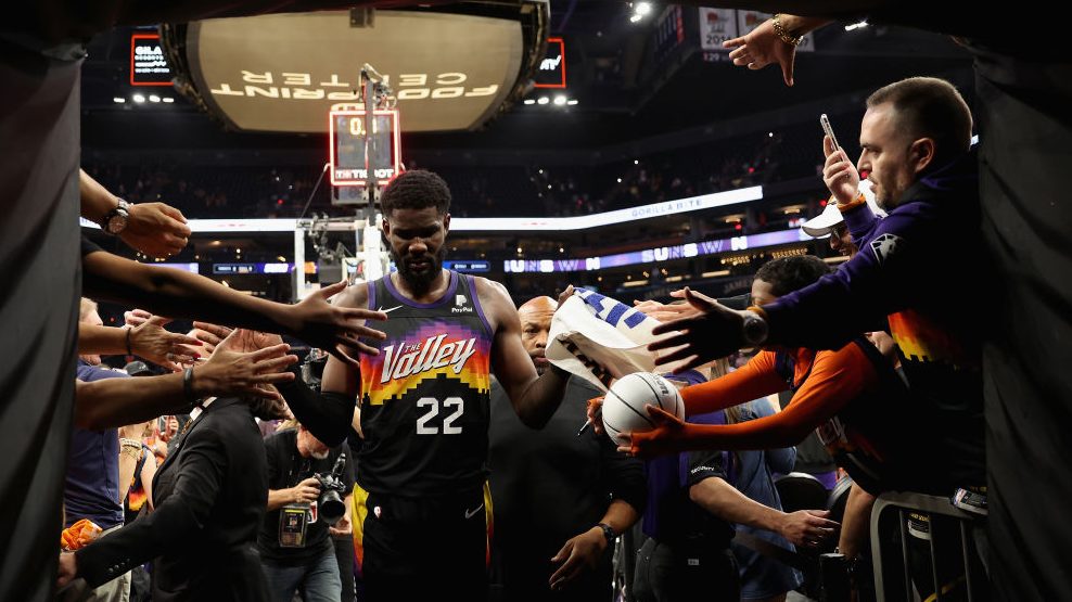 Deandre Ayton #22 of the Phoenix Suns high fives fans as he walks off the court following game one ...
