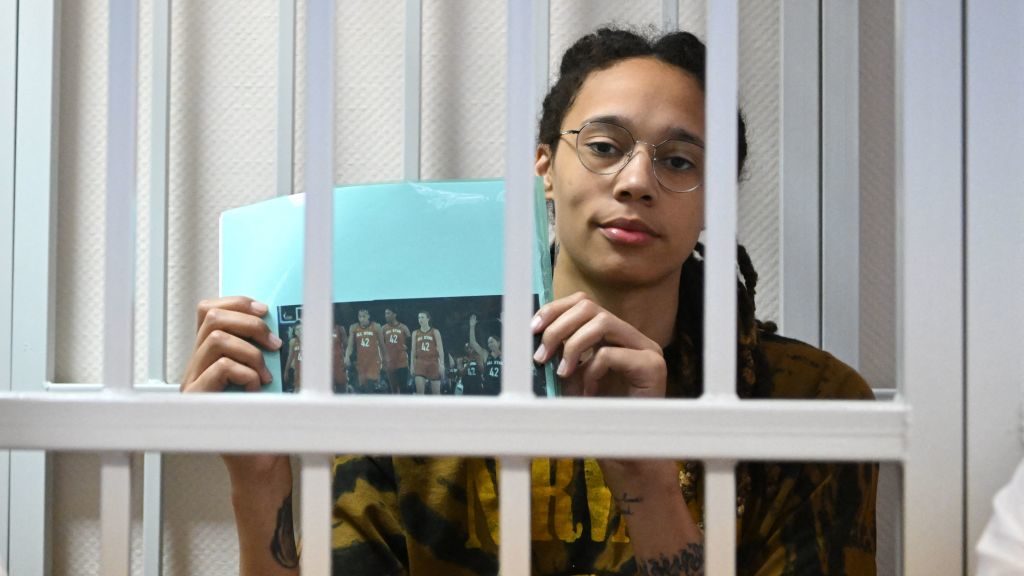 WNBA basketball superstar Brittney Griner sits inside a defendants' cage during a hearing at the Kh...