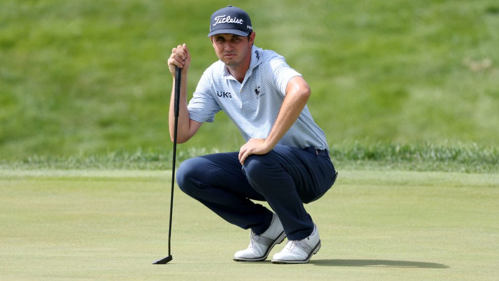 J.T. Poston of the United States lines up a putt on the 14th green during the third round of the Jo...