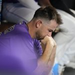Colorado Rockies starting pitcher Austin Gomber sits in the dugout after being pulled from the mound after he gave up a solo home run to Arizona Diamondbacks' Ketel Marte during the sixth inning of a baseball game Saturday, July 2, 2022, in Denver. (AP Photo/David Zalubowski)