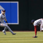 Washington Nationals center fielder Victor Robles, right, is unable to make a play on a double hit by Arizona Diamondbacks' Jake McCarthy as left fielder Lane Thomas, left, watches during the fourth inning of a baseball game Saturday, July 23, 2022, in Phoenix. (AP Photo/Ross D. Franklin)