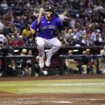 Colorado Rockies' C.J. Cron leaps after being hit by a pitch from Arizona Diamondbacks' Zac Gallen during the fifth inning of a baseball game Friday, July 8, 2022, in Phoenix. (AP Photo/Ross D. Franklin)