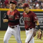 Arizona Diamondbacks' Alek Thomas and Daulton Varsho walk off the field after both made separate diving catches against the Colorado Rockies during the first inning of a baseball game, Sunday July 10, 2022, in Phoenix. (AP Photo/Darryl Webb)
