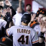 San Francisco Giants' Wilmer Flores (41) celebrates his two-run home run against the Arizona Diamondbacks with teammates in the dugout during the third inning of a baseball game Tuesday, July 26, 2022, in Phoenix. (AP Photo/Ross D. Franklin)