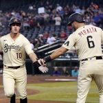 Arizona Diamondbacks' Josh Rojas (10) celebrates his home run against the Colorado Rockies with David Peralta (6) during the first inning of a baseball game Friday, July 8, 2022, in Phoenix. (AP Photo/Ross D. Franklin)