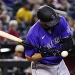 Colorado Rockies' C.J. Cron gets hit by an Arizona Diamondbacks pitch during the fifth inning of a baseball game Friday, July 8, 2022, in Phoenix. (AP Photo/Ross D. Franklin)