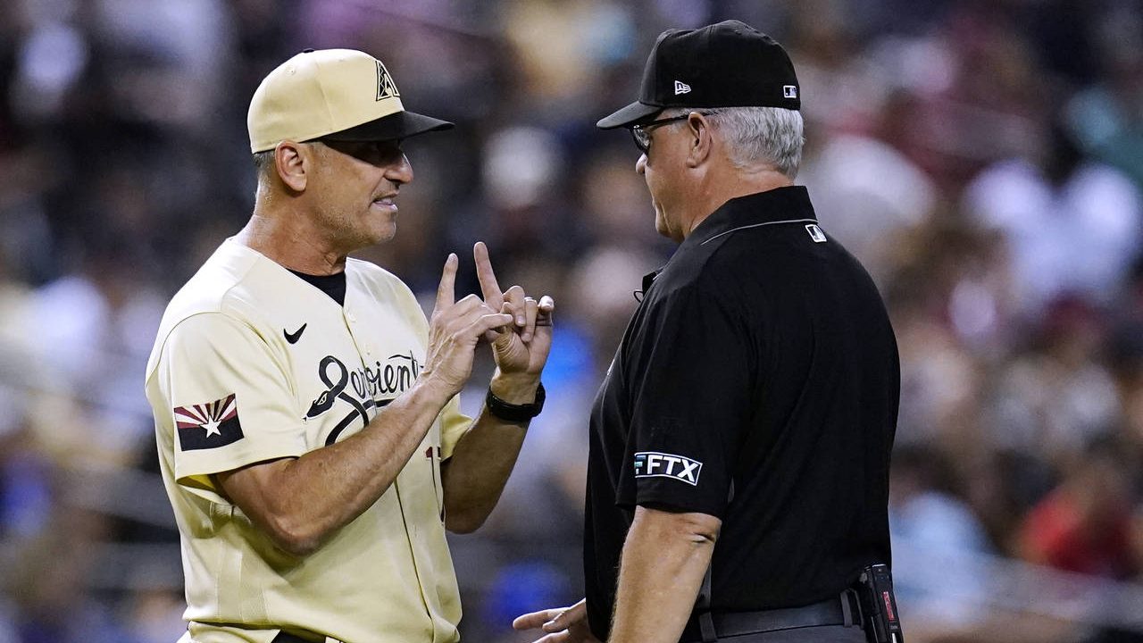 Arizona Diamondbacks manager Torey Lovullo, left, argues with umpire Paul Emmel during the fifth in...