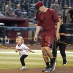 After being announced to the All-Star game, Arizona Diamondbacks pitcher Joe Mantiply runs the bases with his daughter Katherine, 2, after a baseball game against the Colorado Rockies, Sunday July 10, 2022, in Phoenix. (AP Photo/Darryl Webb)