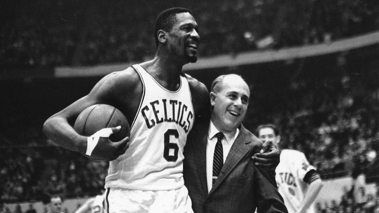 Bill Russell, left, star of the Boston Celtics is congratulated by coach Arnold "Red" Auerbach afte...