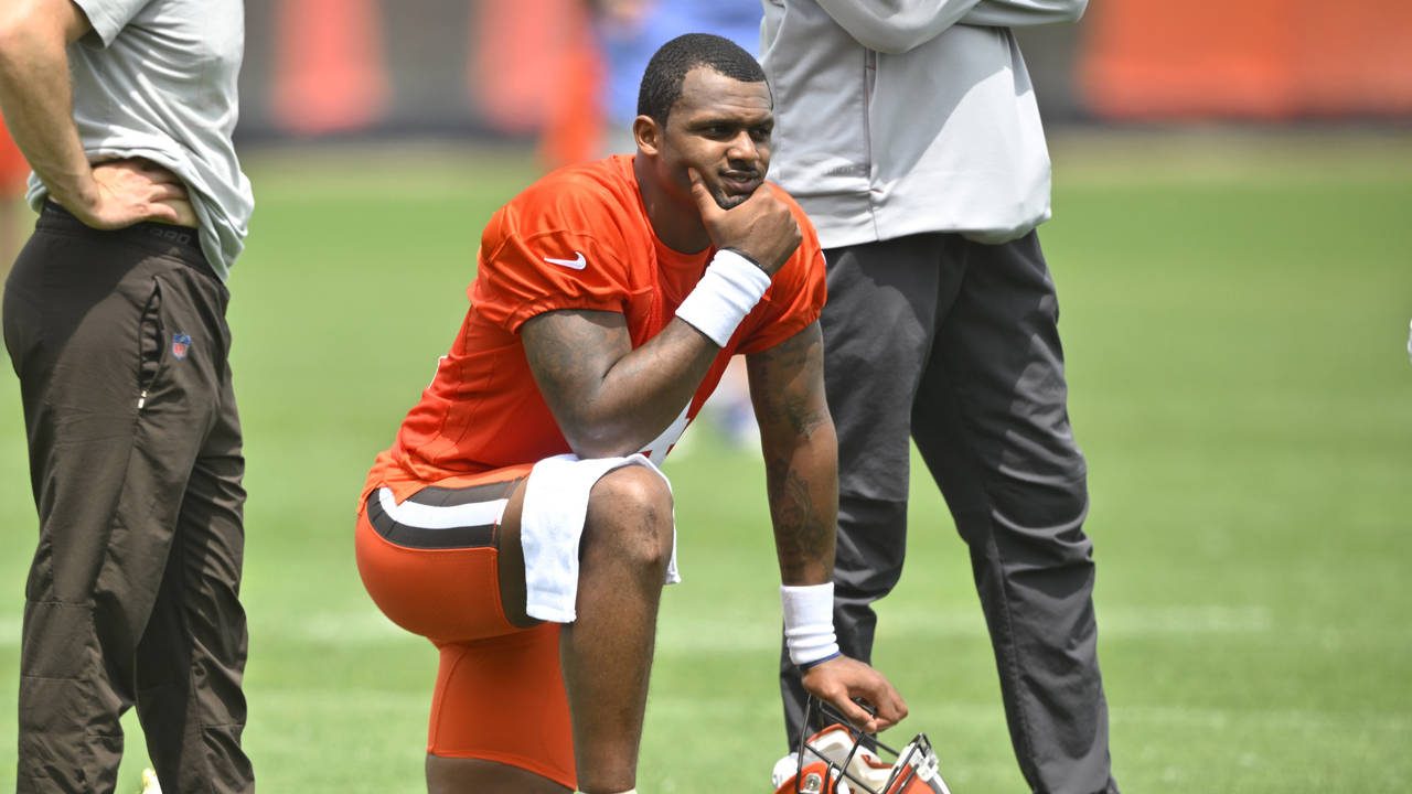 FILE - Cleveland Browns quarterback Deshaun Watson kneels on the field during an NFL football pract...