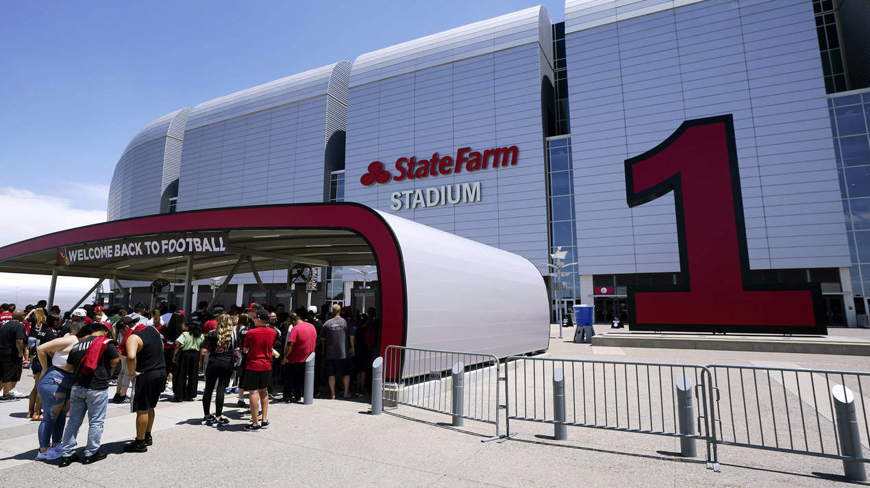 Arizona Cardinals fans line up prior to watching practice at the NFL football team's training camp ...