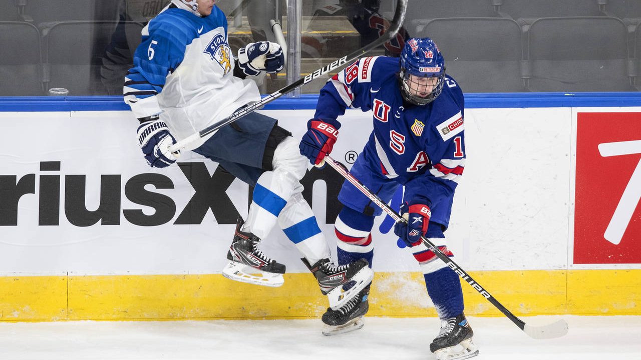 FILE - United States' Logan Cooley (18) checks Finland's Eemil Viro (6) during the second period of...
