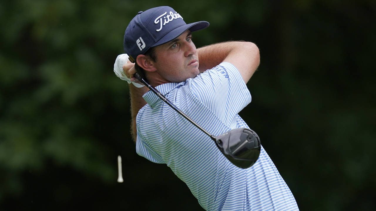 J.T. Poston hits off the second tee during the third round of the John Deere Classic golf tournamen...