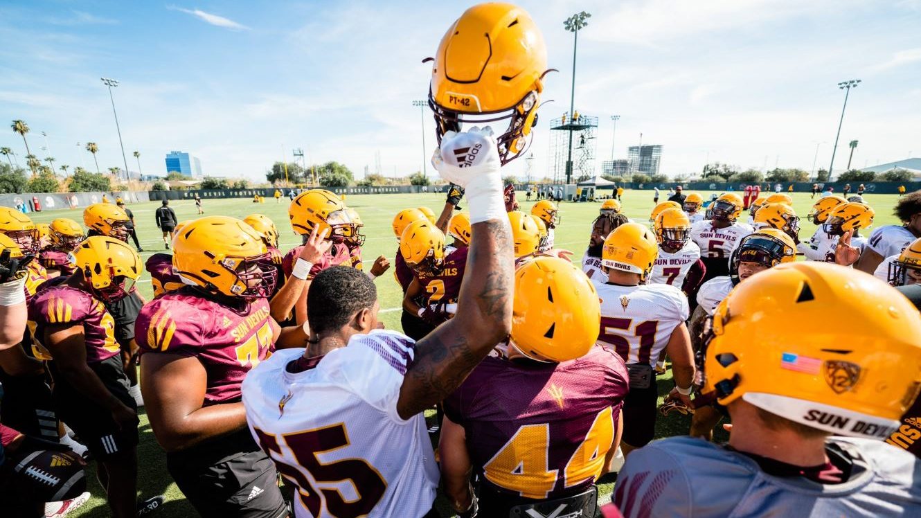 The Arizona State Sun Devils football team breaks down a huddle during a fall camp practice in Augu...