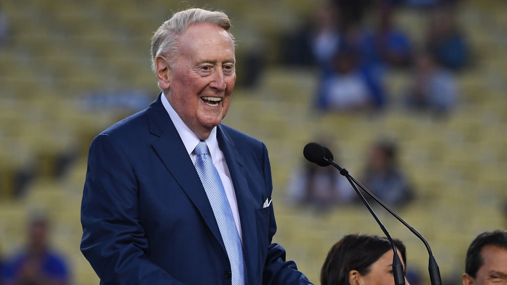 Retired Dodgers broadcaster Vin Scully, left speaks during a pregame ceremony honoring language bro...