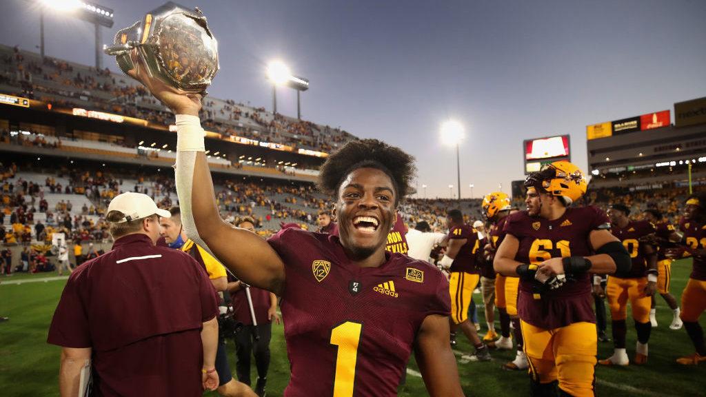 Defensive back Jordan Clark #1 of the Arizona State Sun Devils celebrates with the Territorial Cup ...