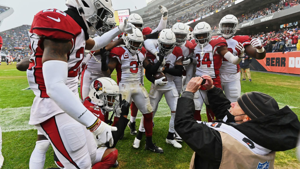 The Arizona Cardinals defense celebrate and pose for a picture in front of a media photographer aft...