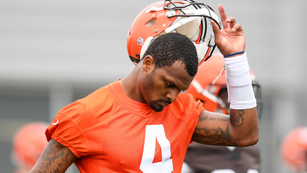 Deshaun Watson #4 of the Cleveland Browns takes off his helmet as he warms up during the Cleveland ...