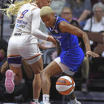 Connecticut Sun guard Courtney Williams (10) takes the ball away from Phoenix Mercury guard Sophie Cunningham (9) during a WNBA basketball game Tuesday, Aug. 2, 2022, in Uncasville, Conn. (Sean D. Elliot/The Day via AP)