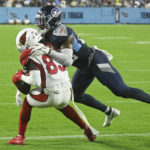 Arizona Cardinals wide receiver Greg Dortch (83) catches a touchdown pass as he is hit by Tennessee Titans safety Theo Jackson (29) in the second half of a preseason NFL football game Saturday, Aug. 27, 2022, in Nashville, Tenn. (AP Photo/John Amis)