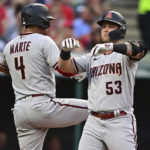 Arizona Diamondbacks' Christian Walker, right, is congratulated by Ketel Marte after hitting a three-run home run off Cleveland Guardians starting pitcher Cal Quantrill during the fourth inning of a baseball game, Monday, Aug. 1, 2022, in Cleveland. (AP Photo/David Dermer)