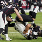 Baltimore Ravens wide receiver Raleigh Webb is tackled by Arizona Cardinals safety James Wiggins, right, during the first half of an NFL preseason football game, Sunday, Aug. 21, 2022, in Glendale, Ariz. (AP Photo/Darryl Webb)