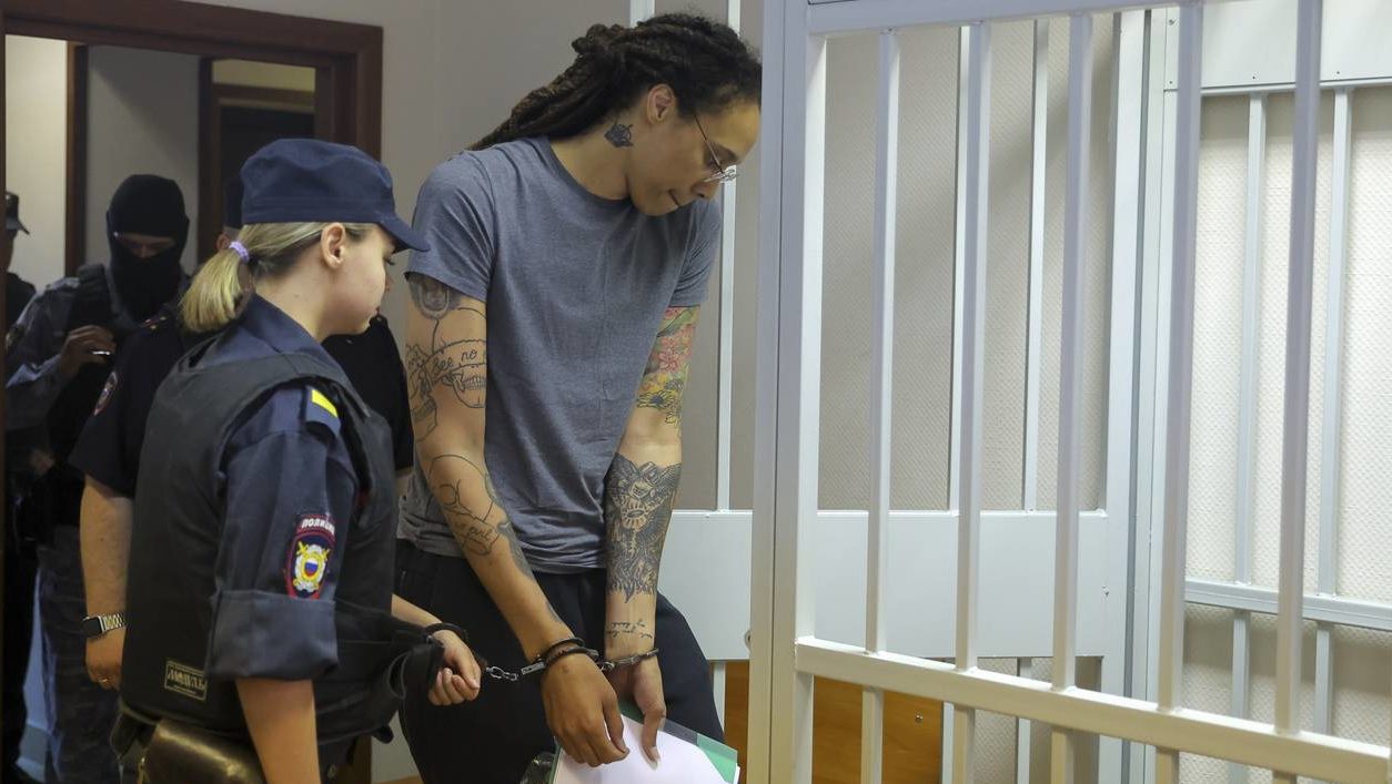WNBA star and two-time Olympic gold medalist Brittney Griner, right, enters a cage in a courtroom p...