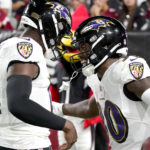 Baltimore Ravens running back Tyler Badie (30) celebrate his touchdown with quarterback Tyler Huntley, left, during the second half of an NFL preseason football game against the Arizona Cardinals, Sunday, Aug. 21, 2022, in Glendale, Ariz. (AP Photo/Darryl Webb)