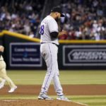 Colorado Rockies starting pitcher German Marquez (48) pauses on the mound after giving up a home run to Arizona Diamondbacks' Daulton Varsho, left, during the fourth inning of a baseball game Friday, Aug. 5, 2022, in Phoenix. (AP Photo/Ross D. Franklin)