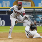 Arizona Diamondbacks shortstop Geraldo Perdomo (2) forces out Chicago White Sox's Elvis Andrus (1) at second base then throws to first base to complete a double play during the fifth inning of a baseball game, Saturday, Aug. 27, 2022, in Chicago. (AP Photo/David Banks)