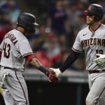 Arizona Diamondbacks' Carson Kelly, right, is congratulated by Sergio Alcantara after hitting a solo home run off Cleveland Guardians relief pitcher Enyel De Los Santos during the seventh inning of a baseball game Tuesday, Aug. 2, 2022, in Cleveland. The Diamondbacks won 6-3. (AP Photo/David Dermer)