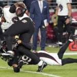 Baltimore Ravens tight end Isaiah Likely (80) is tackled by Arizona Cardinals cornerback Jace Whittaker during the first half of an NFL preseason football game, Sunday, Aug. 21, 2022, in Glendale, Ariz. (AP Photo/Darryl Webb)