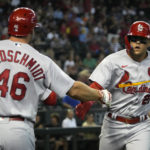St. Louis Cardinals' Lars Nootbaar celebrates with Paul Goldschmidt (46) after hitting a leadoff home run against the Arizona Diamondbacks in the first inning during a baseball game, Sunday, Aug. 21, 2022, in Phoenix. (AP Photo/Rick Scuteri)