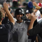 
              New York Yankees' Gleyber Torres, center, celebrates with teammates in the dugout after scoring on a sacrifice fly hit by Aaron Hicks during the fifth inning of a baseball game against the Los Angeles Angels in Anaheim, Calif., Wednesday, Aug. 31, 2022. (AP Photo/Ashley Landis)
            