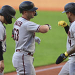 Arizona Diamondbacks' Christian Walker, center, is congratulated by Ketel Marte, right, and Alek Thomas after hitting a three-run home run off Cleveland Guardians starting pitcher Triston McKenzie during the first inning of a baseball game Tuesday, Aug. 2, 2022, in Cleveland. (AP Photo/David Dermer)