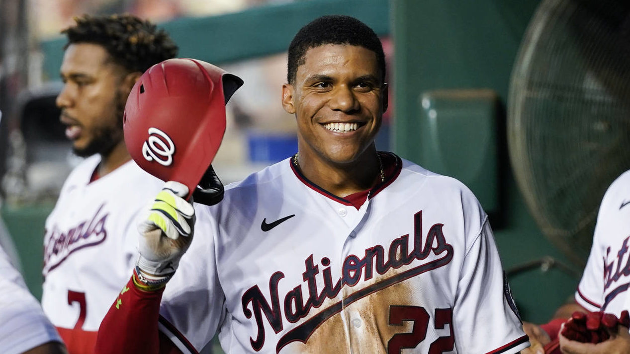 Washington Nationals' Juan Soto smiles as he celebrates after his solo home run during the fourth i...