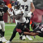 Baltimore Ravens running back Mike Davis (28) is tackled by Arizona Cardinals linebacker Zaven Collins (25) during the first half of an NFL preseason football game, Sunday, Aug. 21, 2022, in Glendale, Ariz. (AP Photo/Rick Scuteri)