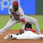 Cleveland Guardians' Steven Kwan, bottom, is safe on a steal of second base as Arizona Diamondbacks shortstop Geraldo Perdomo, top, is late on the tag during the seventh inning of a baseball game, Monday, Aug. 1, 2022, in Cleveland. (AP Photo/David Dermer)