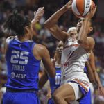 Phoenix Mercury guard Skylar Diggins-Smith (4) shoots after being fouled by Connecticut Sun forward DeWanna Bonner (24) during a WNBA basketball game Tuesday, Aug. 2, 2022, in Uncasville, Conn. (Sean D. Elliot/The Day via AP)