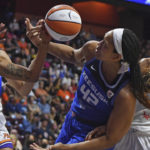 Connecticut Sun center Brionna Jones (42) works for a rebound between Phoenix Mercury guard Jennie Simms (25) and guard Shay Peddy (11) during a WNBA basketball game Tuesday, Aug. 2, 2022, in Uncasville, Conn. (Sean D. Elliot/The Day via AP)