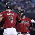 Arizona Diamondbacks' Christian Walker (53) celebrates with Ketel Marte (4) after hitting a two-run home run against the Colorado Rockies during the first inning of a baseball game Sunday, Aug. 7, 2022, in Phoenix. (AP Photo/Ross D. Franklin)