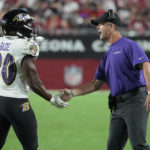 Baltimore Ravens head coach John Harbaugh greets running back Tyler Badie (30) after his touchdown against the Arizona Cardinals during the second half of an NFL preseason football game, Sunday, Aug. 21, 2022, in Glendale, Ariz. (AP Photo/Rick Scuteri)