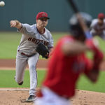 Arizona Diamondbacks starting pitcher Zach Davies, left, delivers to Cleveland Guardians' Amed Rosario during the first inning of a baseball game, Monday, Aug. 1, 2022, in Cleveland. (AP Photo/David Dermer)