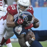 Tennessee Titans quarterback Malik Willis (7) is stopped by Arizona Cardinals linebacker Zaven Collins (25) in the first half of a preseason NFL football game Saturday, Aug. 27, 2022, in Nashville, Tenn. (AP Photo/John Amis)