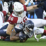 
              Tennessee Titans running back Trenton Cannon (23) is stopped by Arizona Cardinals linebacker Ben Niemann (56) in the first half of a preseason NFL football game Saturday, Aug. 27, 2022, in Nashville, Tenn. (AP Photo/John Amis)
            