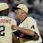 Arizona Diamondbacks manager Torey Lovullo, right, celebrates with shortstop Geraldo Perdomo (2) after the team's 6-5 win over the Colorado Rockies in a baseball game Friday, Aug. 5, 2022, in Phoenix. (AP Photo/Ross D. Franklin)