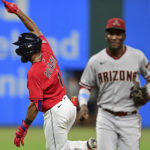 Cleveland Guardians' Amed Rosario, left, celebrates after hitting a RBI-single during the 10th inning of a baseball game against the Arizona Diamondbacks, Monday, Aug. 1, 2022, in Cleveland. (AP Photo/David Dermer)