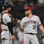 Arizona Diamondbacks relief pitcher Ian Kennedy, right, is congratulated by catcher Carson Kelly after the Diamondbacks defeated the Cleveland Guardians 6-3 in a baseball game Tuesday, Aug. 2, 2022, in Cleveland. (AP Photo/David Dermer)