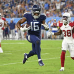 Tennessee Titans wide receiver Treylon Burks (16) leaps into the end zone past Arizona Cardinals cornerback Josh Jackson (36) as Burks scores a touchdown on a 14-yard pass completion in the first half of a preseason NFL football game Saturday, Aug. 27, 2022, in Nashville, Tenn. (AP Photo/Mark Zaleski)